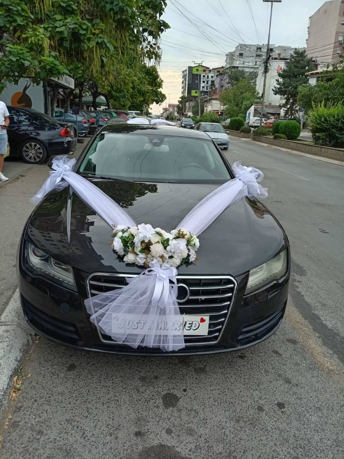 Свадбена декорација на автомобил: бели цвеќиња и тул на хаубата